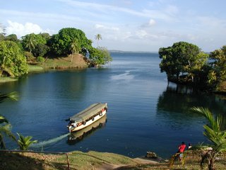 Dugout canoe leaving a small harbor with Lake Gatun in background
